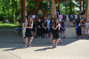 uczniowie przebrani w stroje z lat 20, 30,  tańczą, bawią się w stare gry, śpiewają, przedstawiają, oglądają teatrzyk