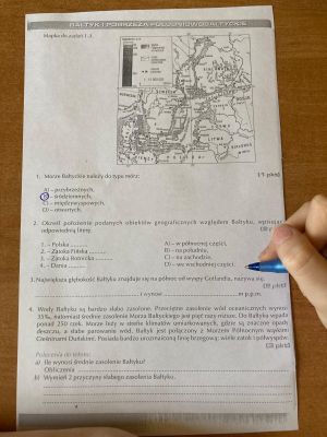 zdjęcie przedstawiające opisaną kartkę oraz dłoń z długopisem